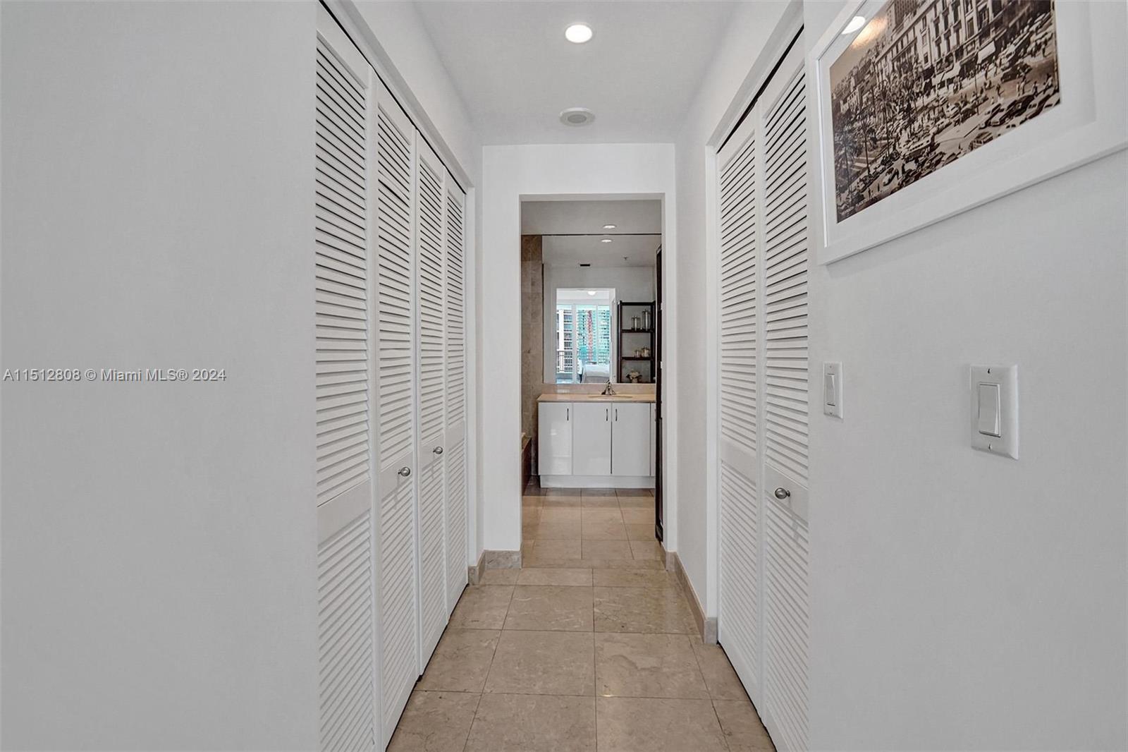 801 Brickell Key Boulevard, Unit 3004 Miami, FL 33131 - Photo 12 of 33 a view of a hallway with wooden floor and a bathroom
