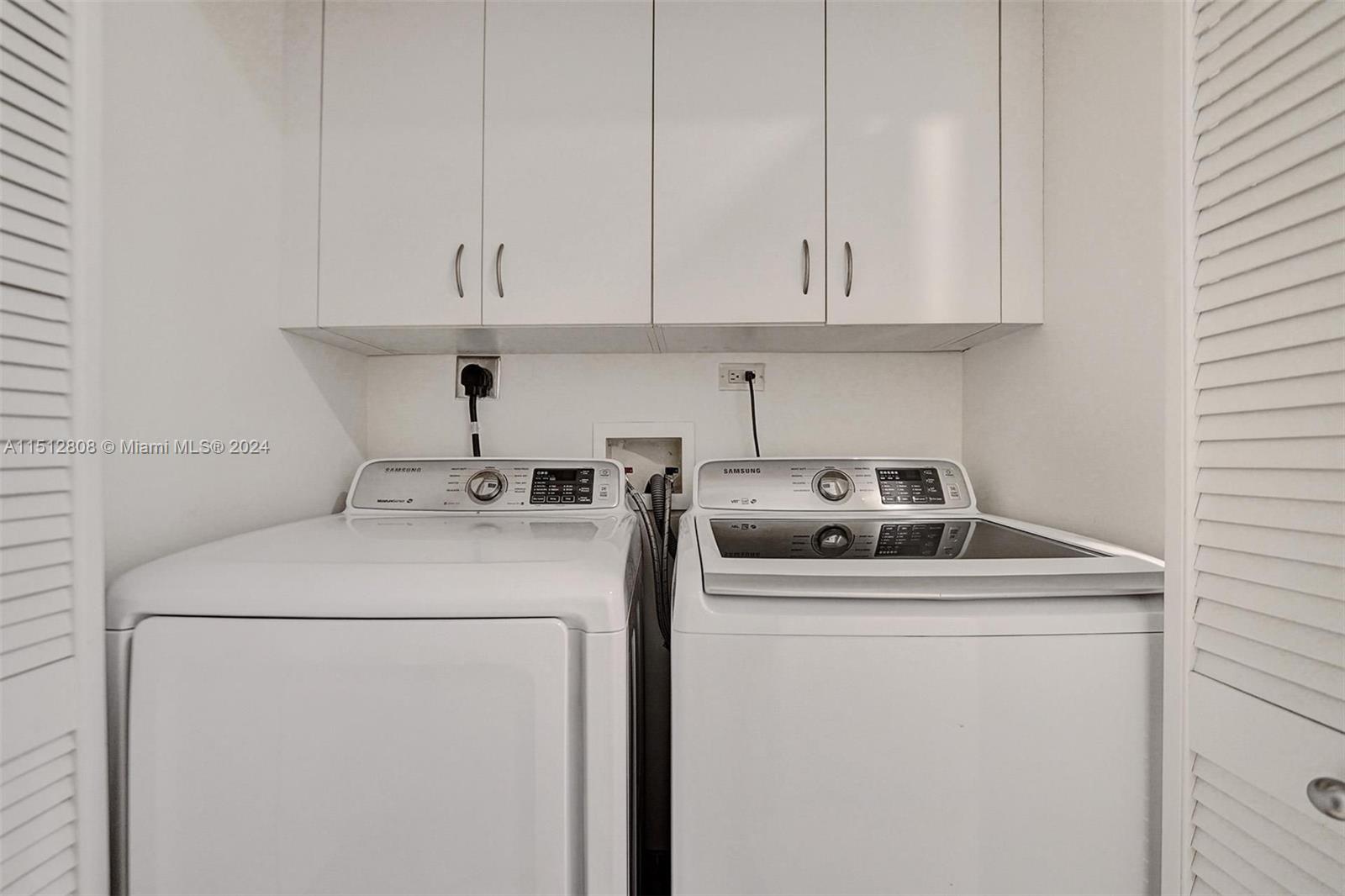 801 Brickell Key Boulevard, Unit 3004 Miami, FL 33131 - Photo 13 of 33 a utility room with dryer and washer