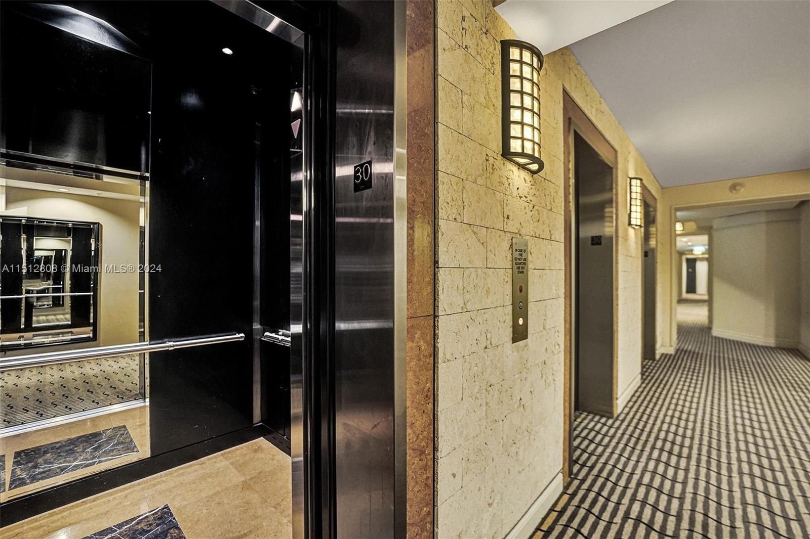 801 Brickell Key Boulevard, Unit 3004 Miami, FL 33131 - Photo 14 of 33 a bathroom with a glass shower door