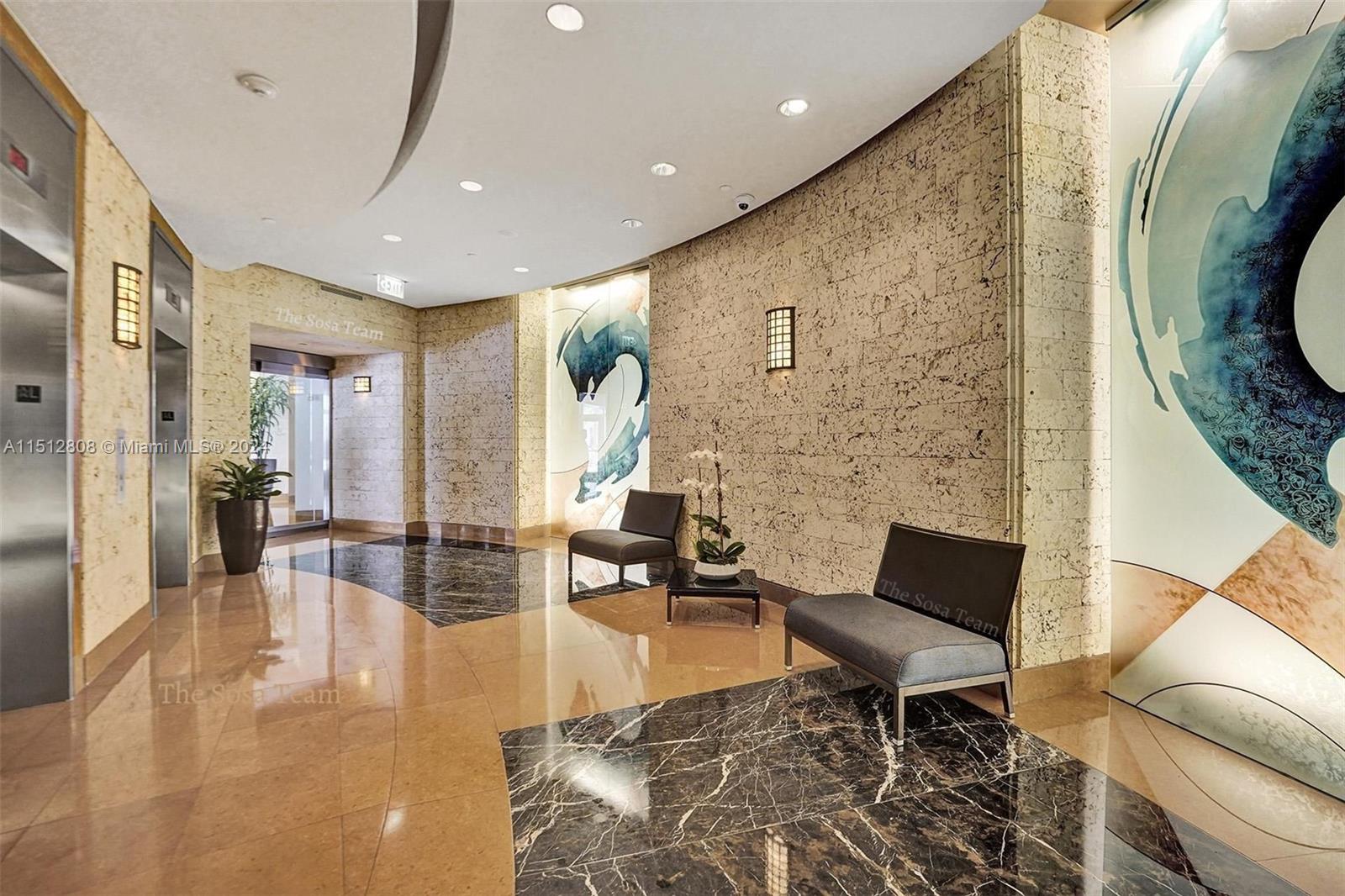 801 Brickell Key Boulevard, Unit 3004 Miami, FL 33131 - Photo 15 of 33 a living room with furniture and wooden floor