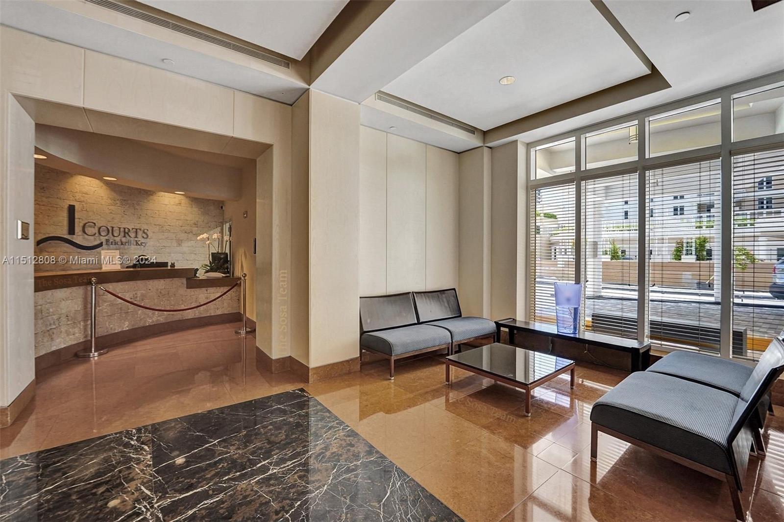 801 Brickell Key Boulevard, Unit 3004 Miami, FL 33131 - Photo 16 of 33 a living room with furniture and a large window