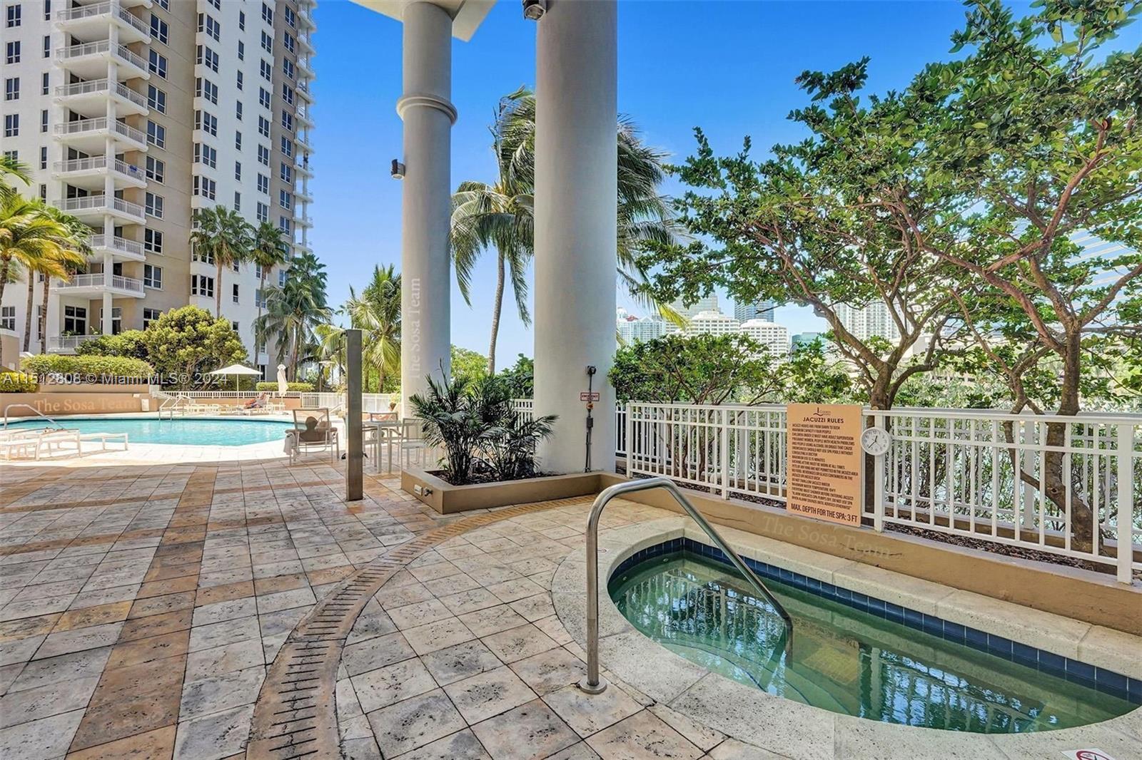 801 Brickell Key Boulevard, Unit 3004 Miami, FL 33131 - Photo 19 of 33 a view of a chair and tables on the patio