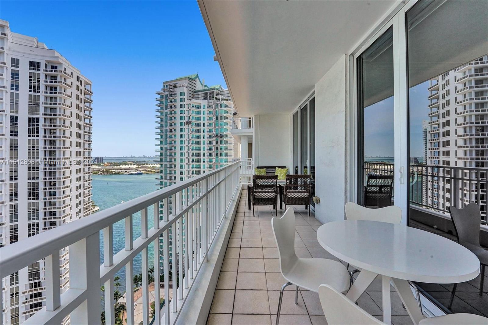 801 Brickell Key Boulevard, Unit 3004 Miami, FL 33131 - Photo 2 of 33 a balcony with table and chairs