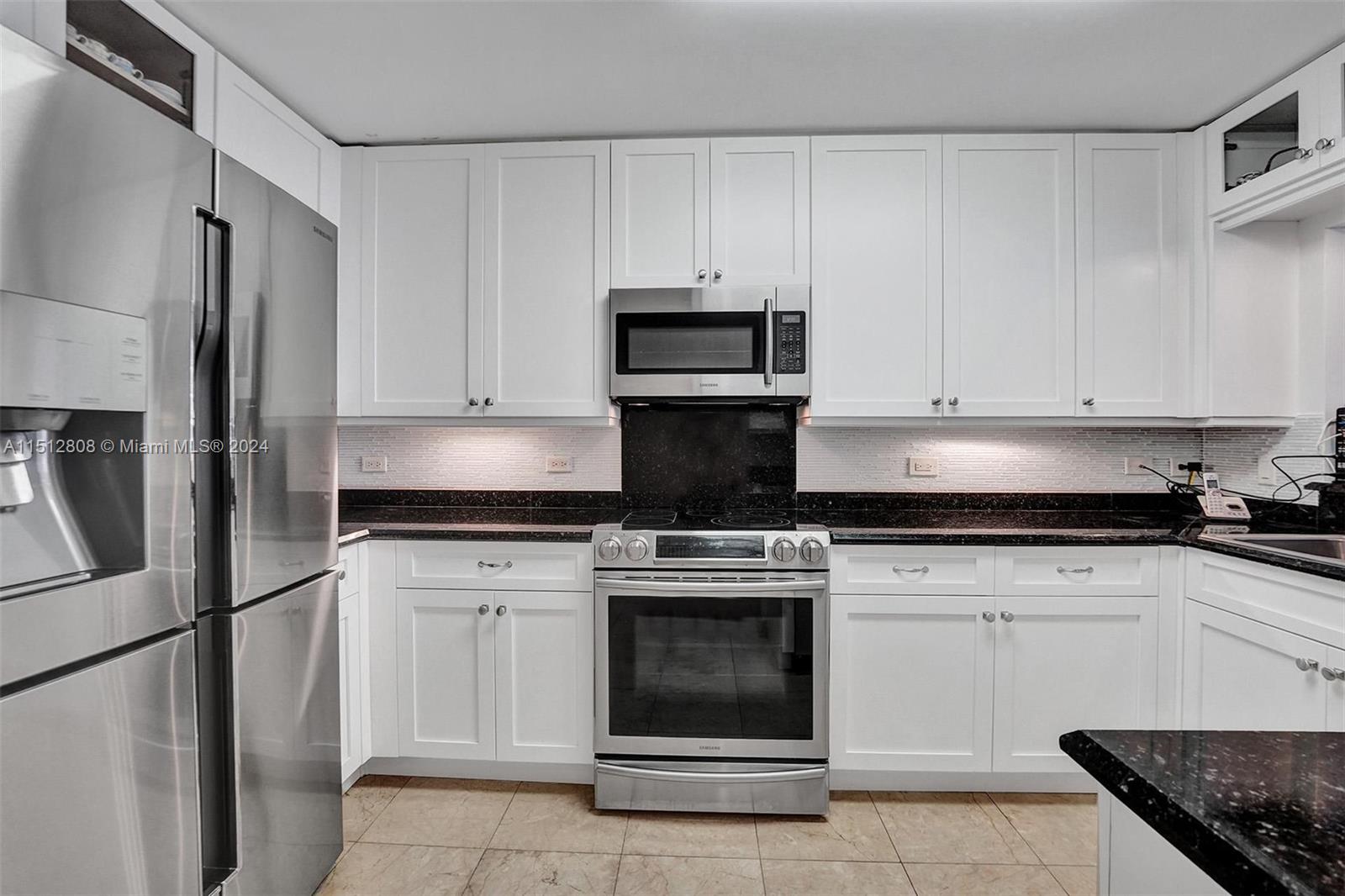 801 Brickell Key Boulevard, Unit 3004 Miami, FL 33131 - Photo 6 of 33 a kitchen with cabinets stainless steel appliances and a counter space