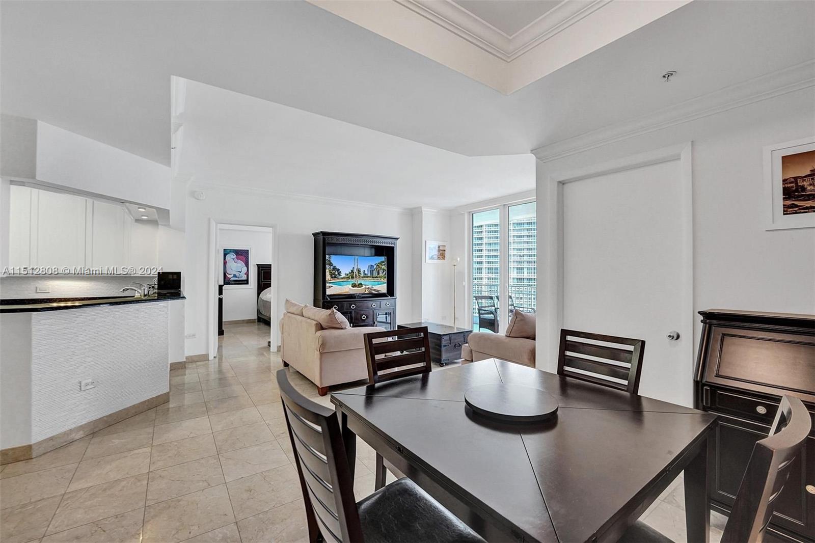 801 Brickell Key Boulevard, Unit 3004 Miami, FL 33131 - Photo 9 of 33 a view of kitchen with dining table and chairs