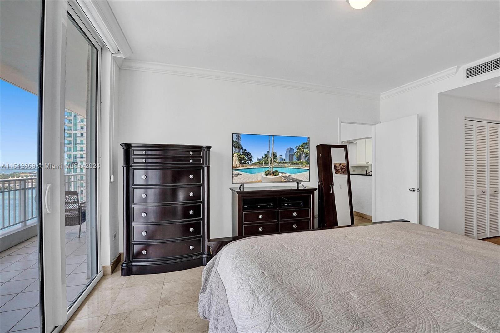 801 Brickell Key Boulevard, Unit 3004 Miami, FL 33131 - Photo 10 of 33 a bedroom with a bed and a dresser