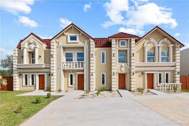 a front view of a building with a yard