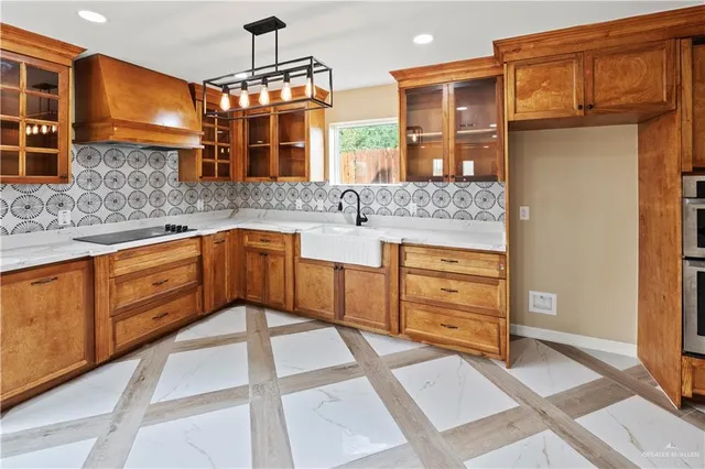 a kitchen with stainless steel appliances granite countertop a sink and cabinets