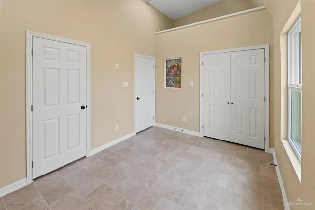 a view of an empty room with windows