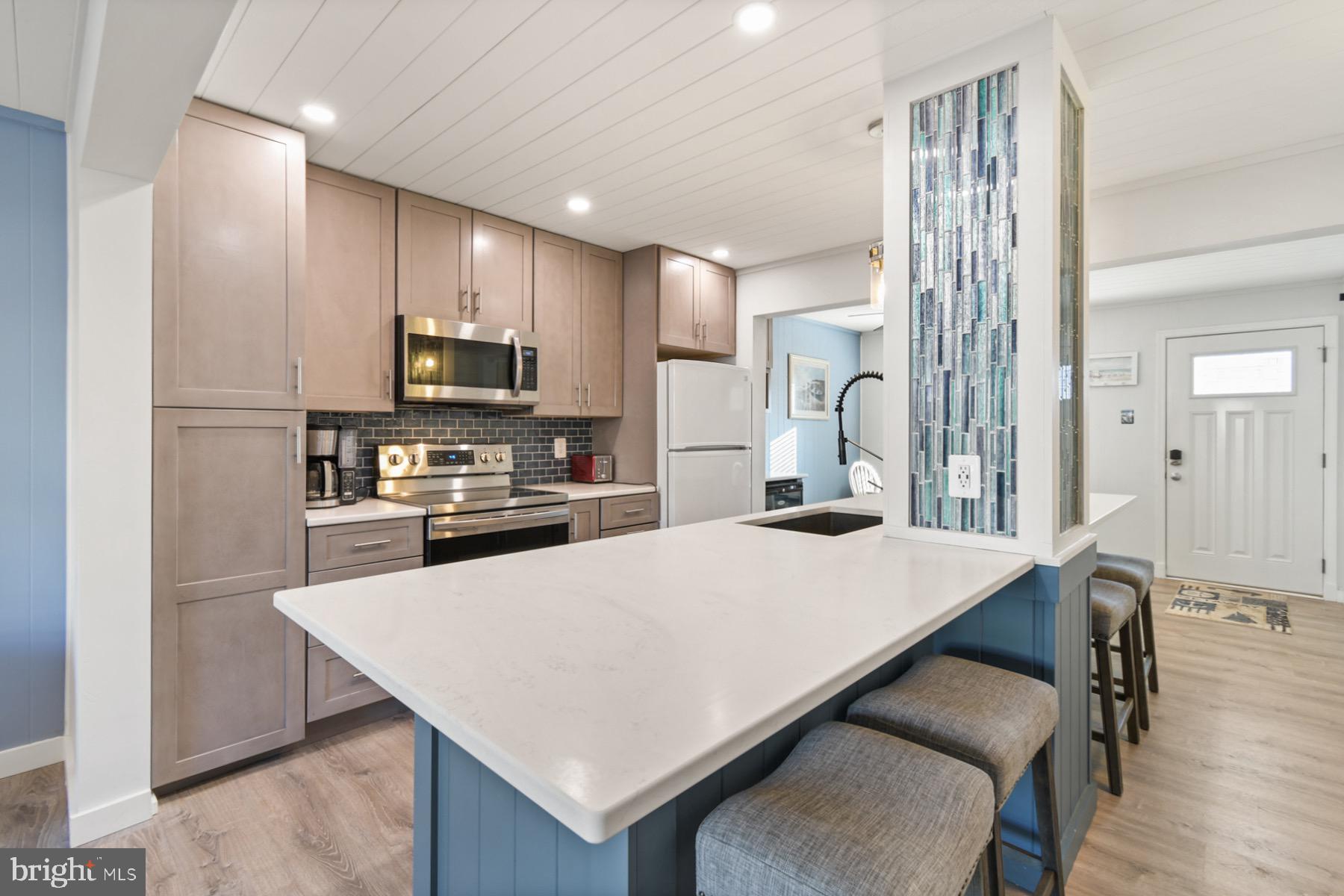 722 Mooring Road, Unit A104 Ocean City, MD 21842 - Photo 10 of 33 a kitchen with stainless steel appliances a refrigerator and a stove top oven