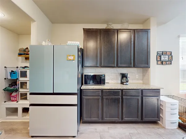 a kitchen with stainless steel appliances granite countertop a refrigerator and a cabinets