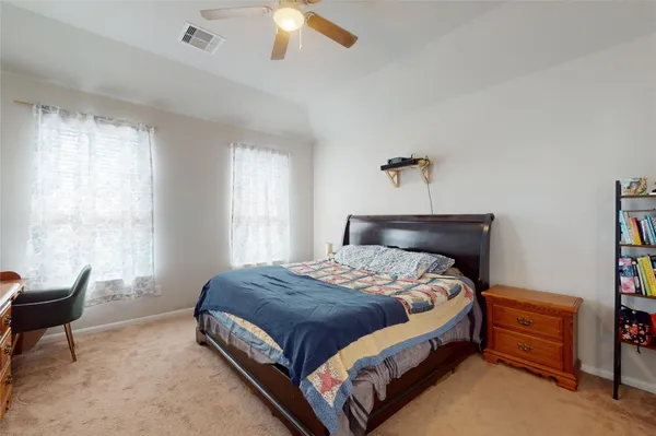 a bedroom with a bed and a window