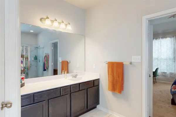 a bathroom with a double vanity sink and a mirror