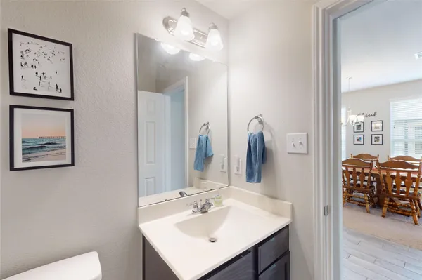 a bathroom with a sink vanity and a mirror