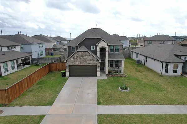 an aerial view of a house with a yard