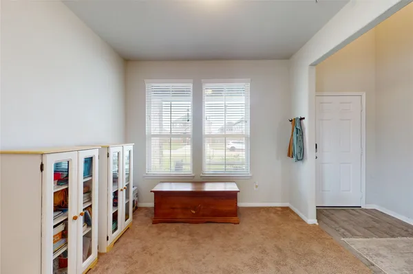 a spacious bedroom with a bed and a window