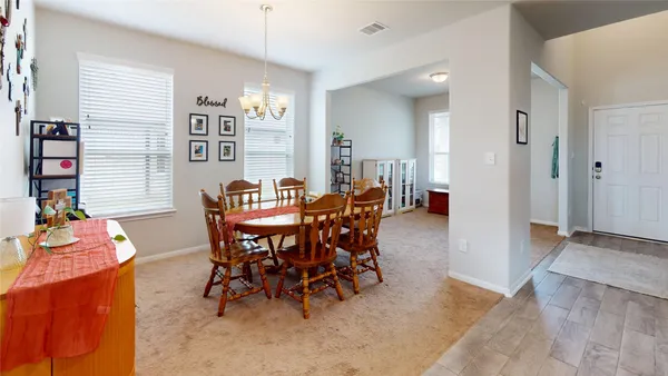 a dining room with furniture and window