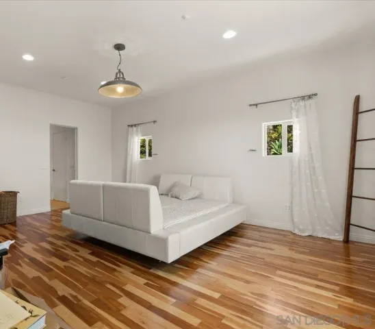 a bedroom with a large bed and a chandelier