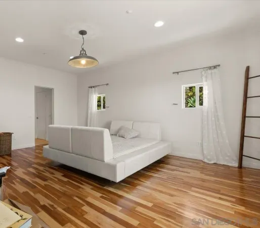 a bedroom with a large bed and a chandelier