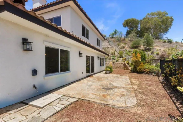 a view of a house with backyard porch and sitting area