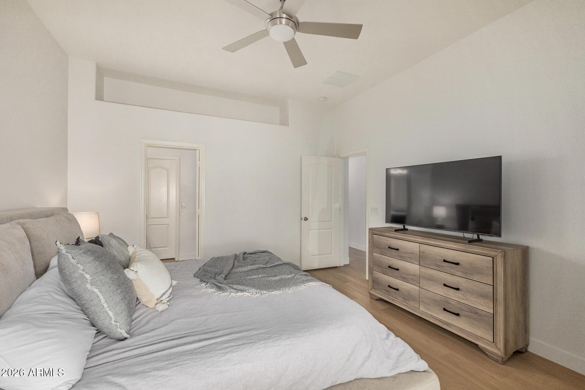 2725 East Mine Creek Road, Unit 1101 Phoenix, AZ 85024 - Photo 19 of 43 a bedroom with a bed and a flat screen tv