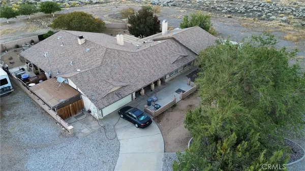 an aerial view of a house with a yard and lake view
