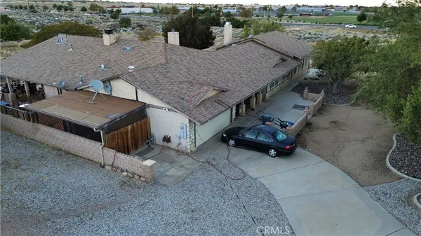 an aerial view of a house with yard