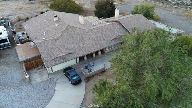 an aerial view of a house with outdoor space and parking spaces