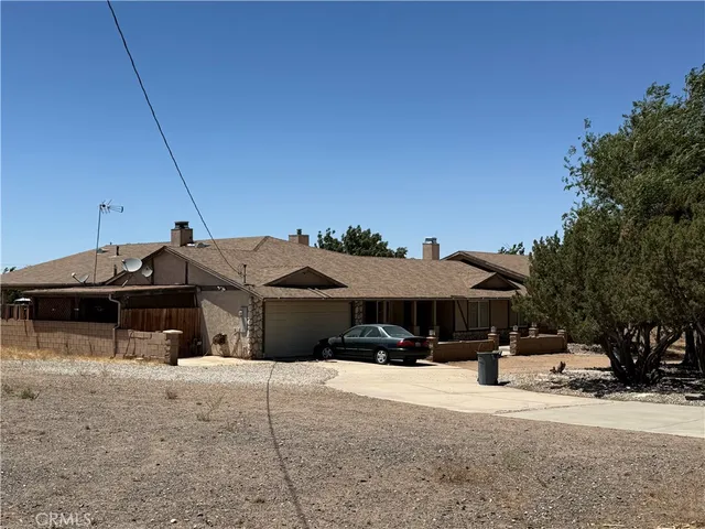 a view of a house with a yard and sitting area