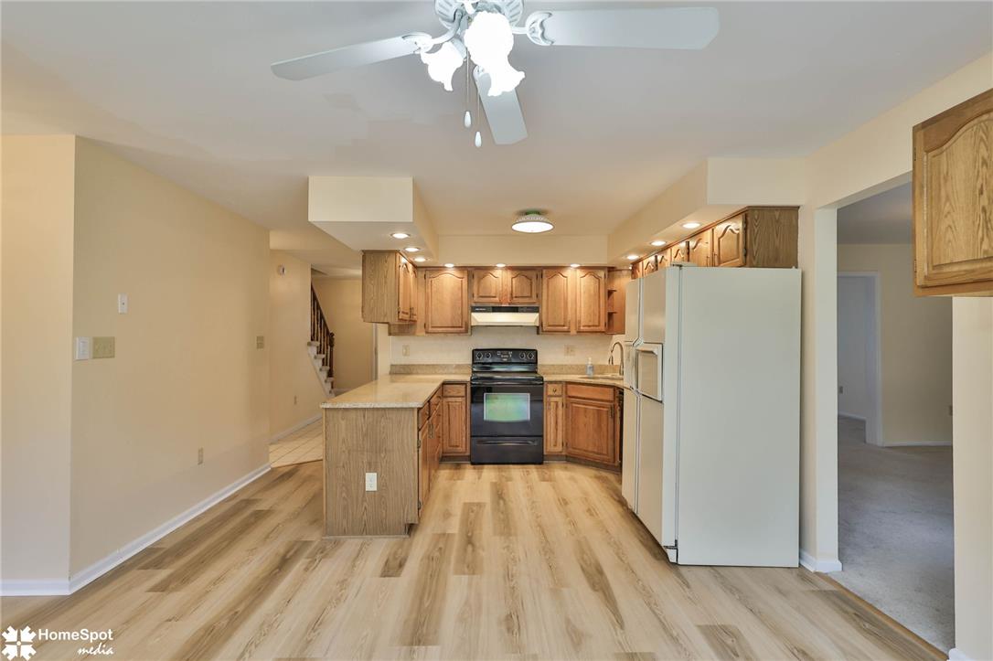 4059 Wedgewood Road Allentown, PA 18104 - Photo 10 of 72 A well-lit kitchen with natural wood cabinetry and resilient flooring awaits culinary adventures.