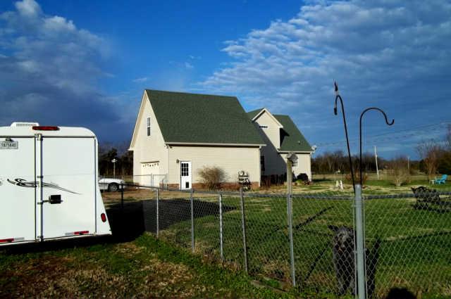 The backyard of home is fenced and has a large aggregate patio .