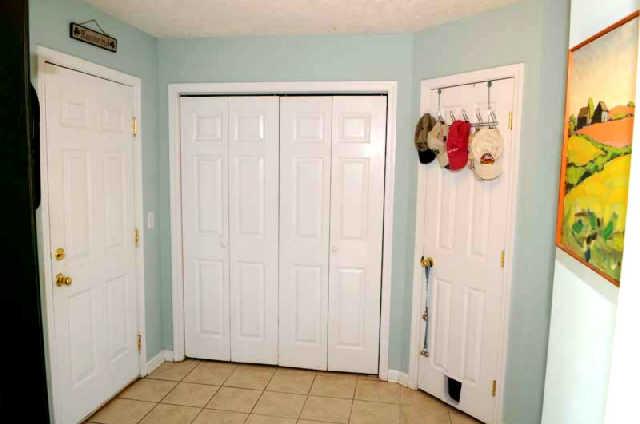 Area off the kitchen has a closet, garage entrance, half bath and pantry. The flooring in this area and kitchen is ceramic tile.
