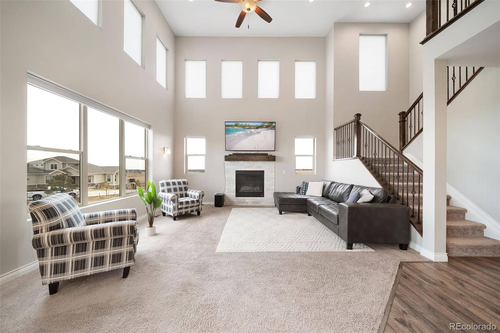 240 High Meadows Loop Elizabeth, CO 80107 - Photo 13 of 50 a living room with furniture a fireplace and a floor to ceiling window