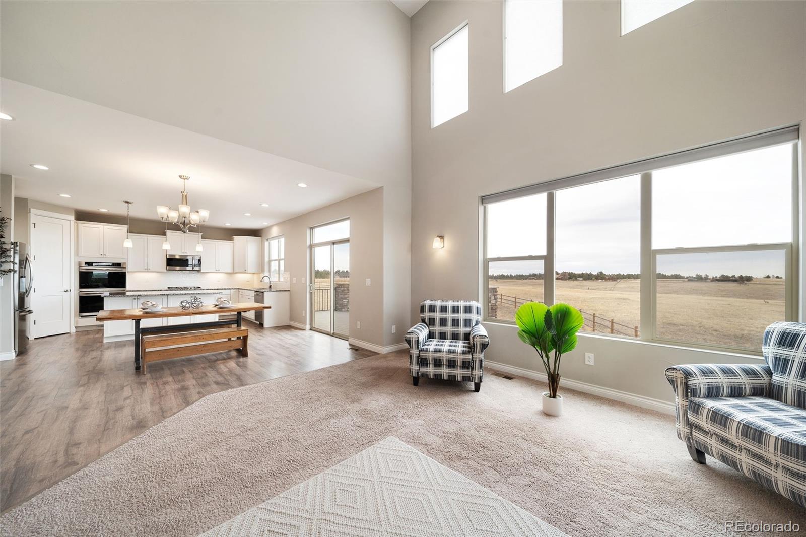 240 High Meadows Loop Elizabeth, CO 80107 - Photo 16 of 50 a living room with furniture and floor to ceiling windows