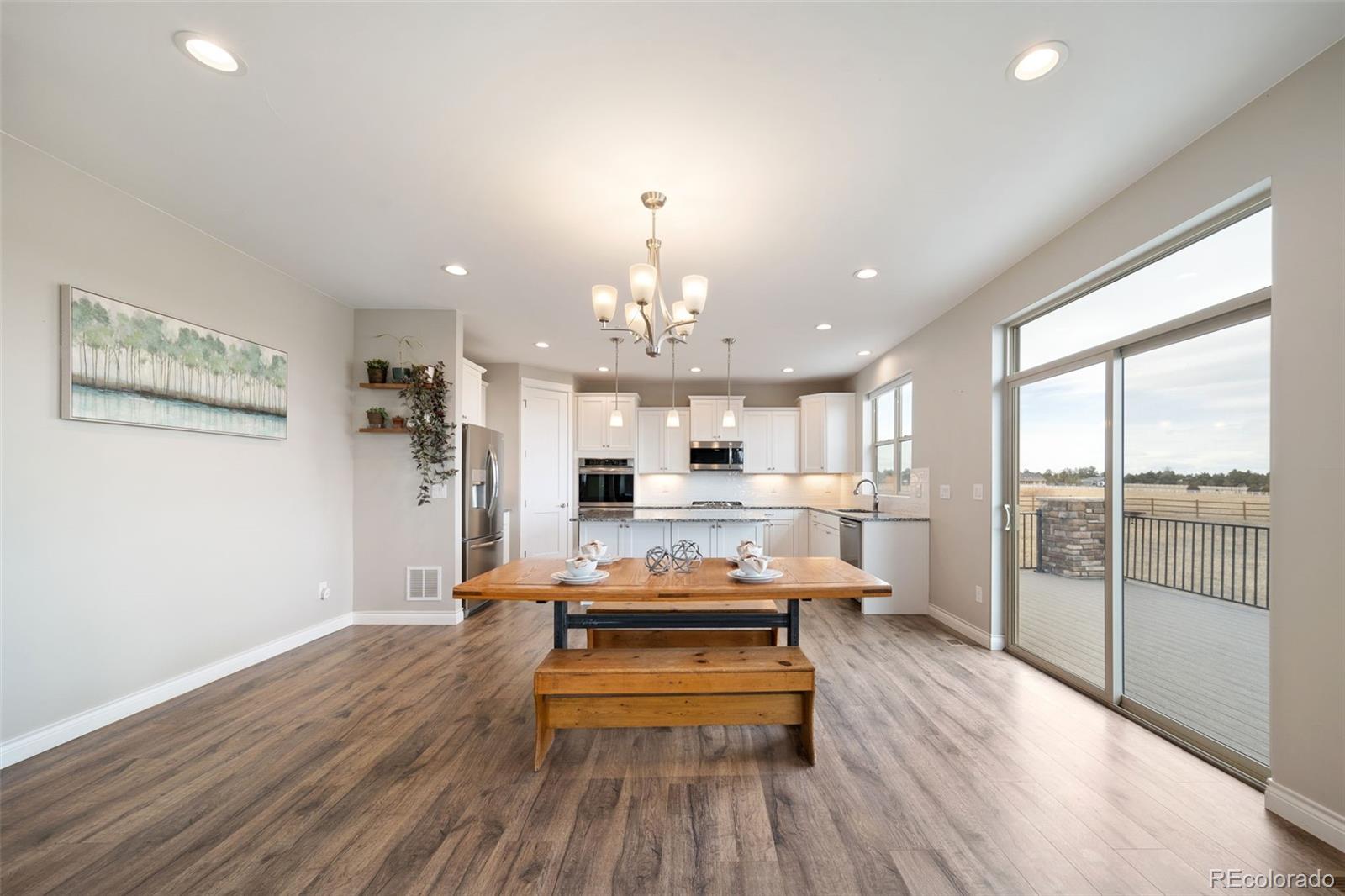 240 High Meadows Loop Elizabeth, CO 80107 - Photo 18 of 50 a large kitchen with sink wooden floor and stainless steel appliances