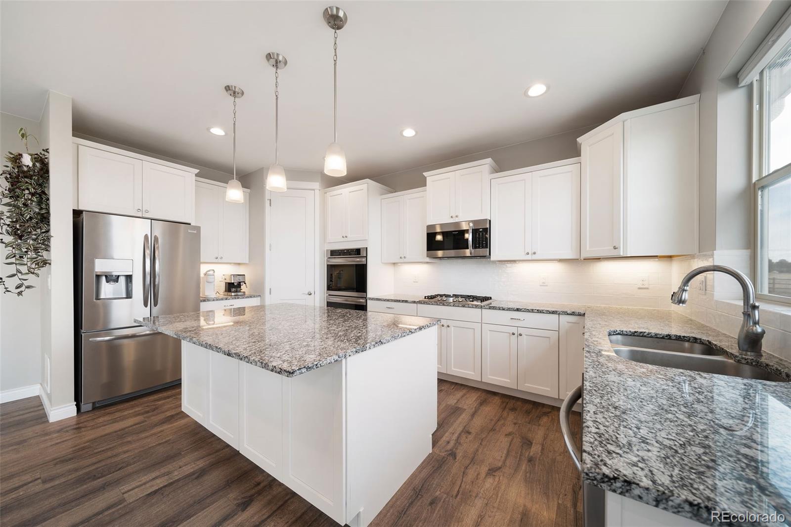 240 High Meadows Loop Elizabeth, CO 80107 - Photo 20 of 50 a kitchen with stainless steel appliances granite countertop a sink refrigerator and cabinets