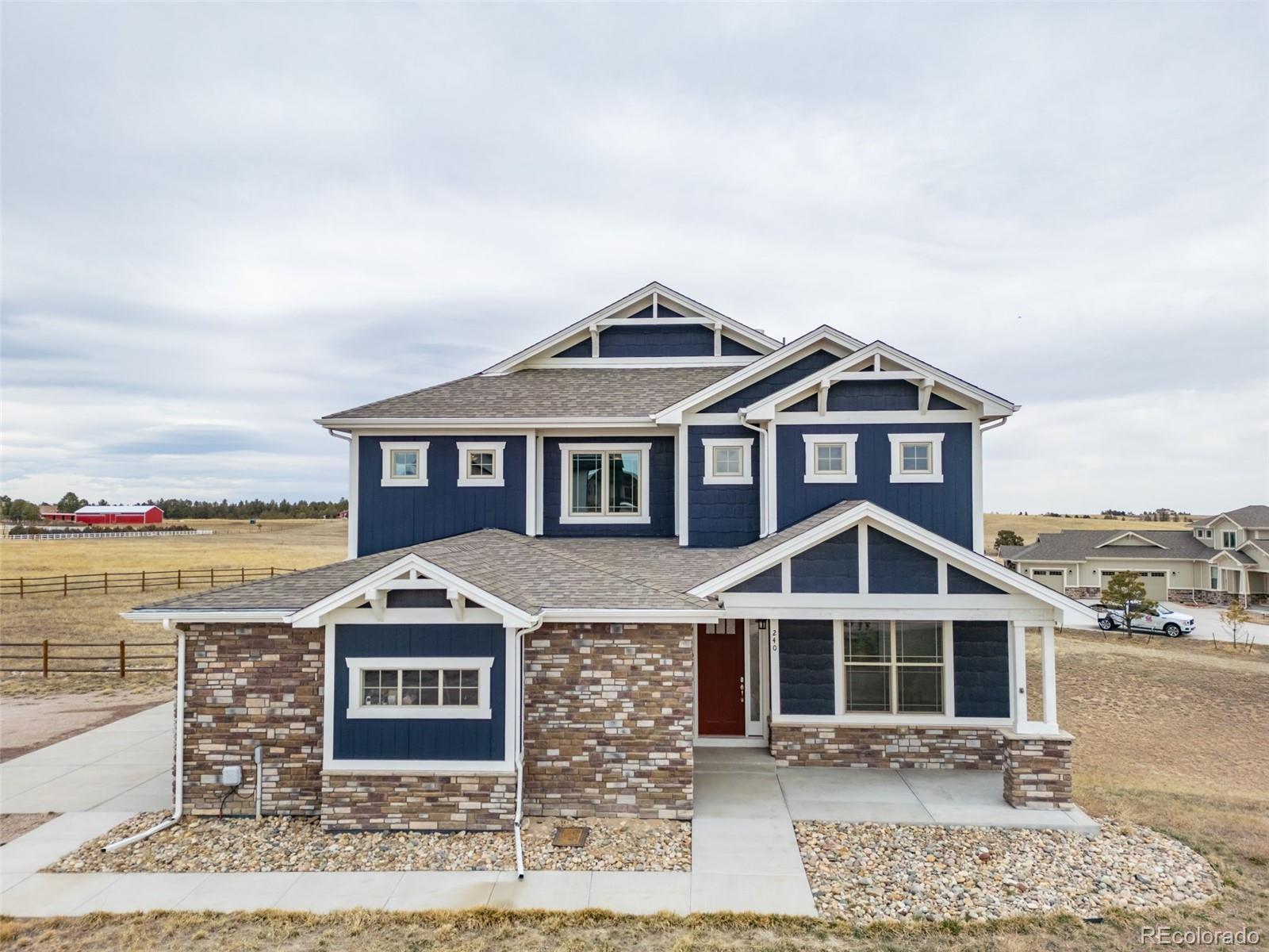 240 High Meadows Loop Elizabeth, CO 80107 - Photo 2 of 50 a front view of a house with a yard
