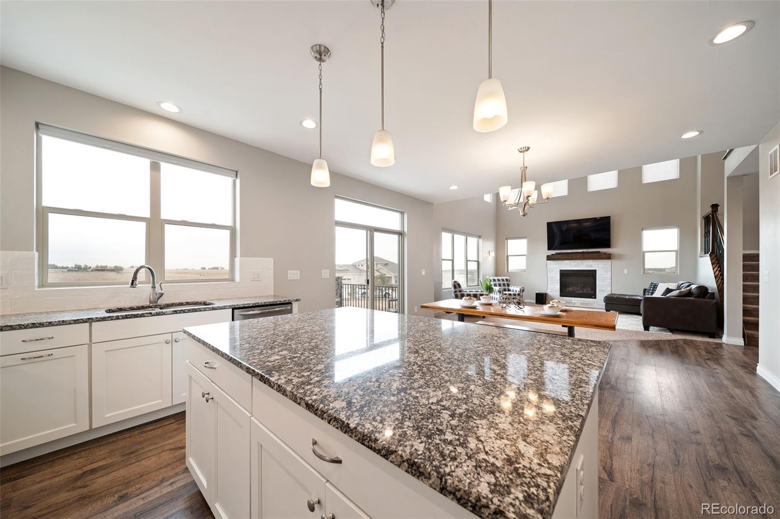 240 High Meadows Loop Elizabeth, CO 80107 - Photo 22 of 50 a view of a kitchen with kitchen island granite countertop a large window and a sink