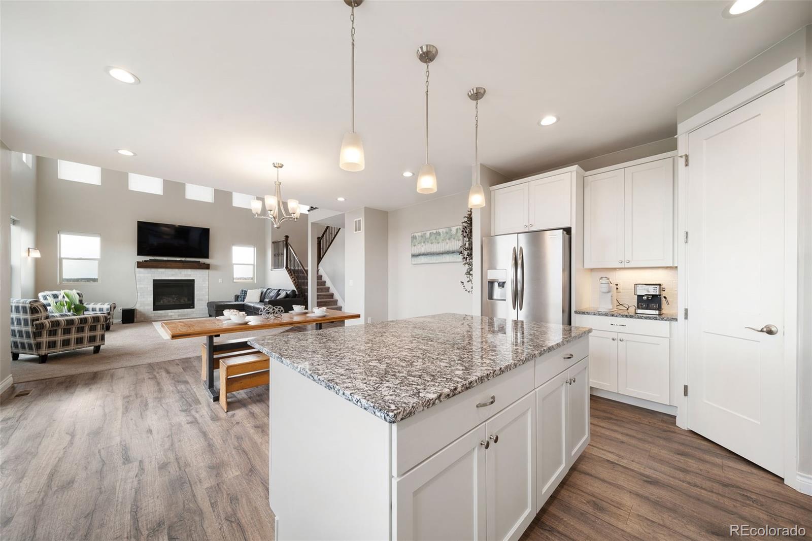 240 High Meadows Loop Elizabeth, CO 80107 - Photo 23 of 50 a kitchen with stainless steel appliances granite countertop a stove refrigerator and cabinets