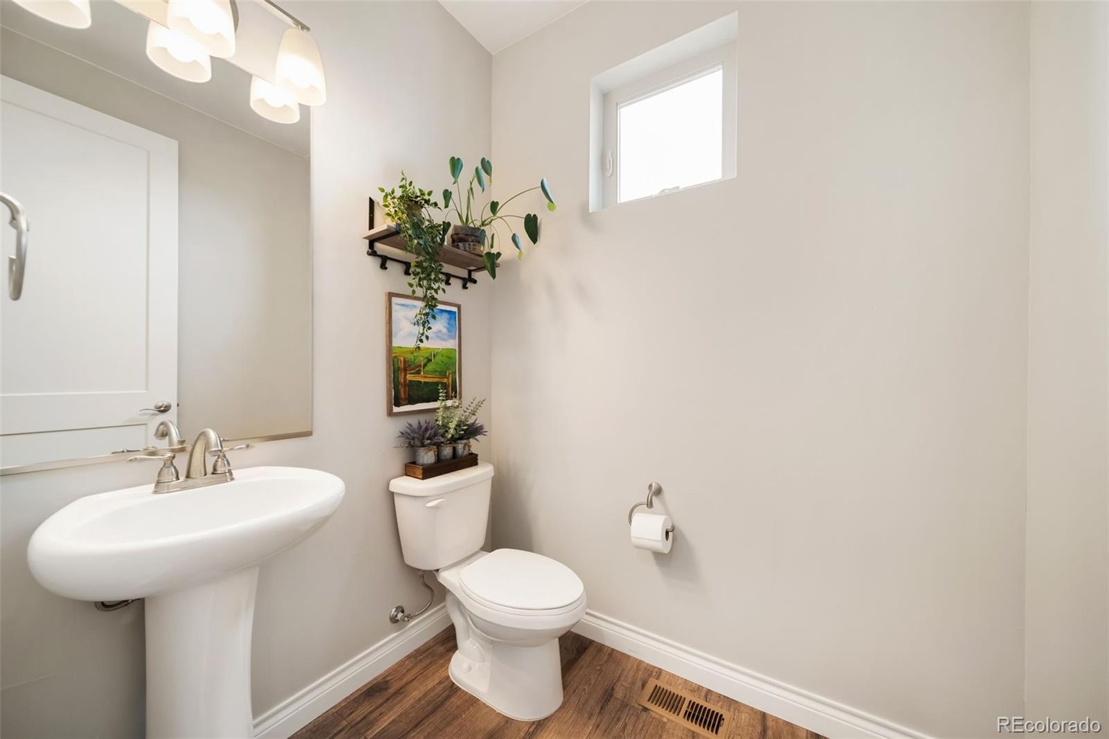 240 High Meadows Loop Elizabeth, CO 80107 - Photo 25 of 50 a bathroom with a sink a toilet and mirror