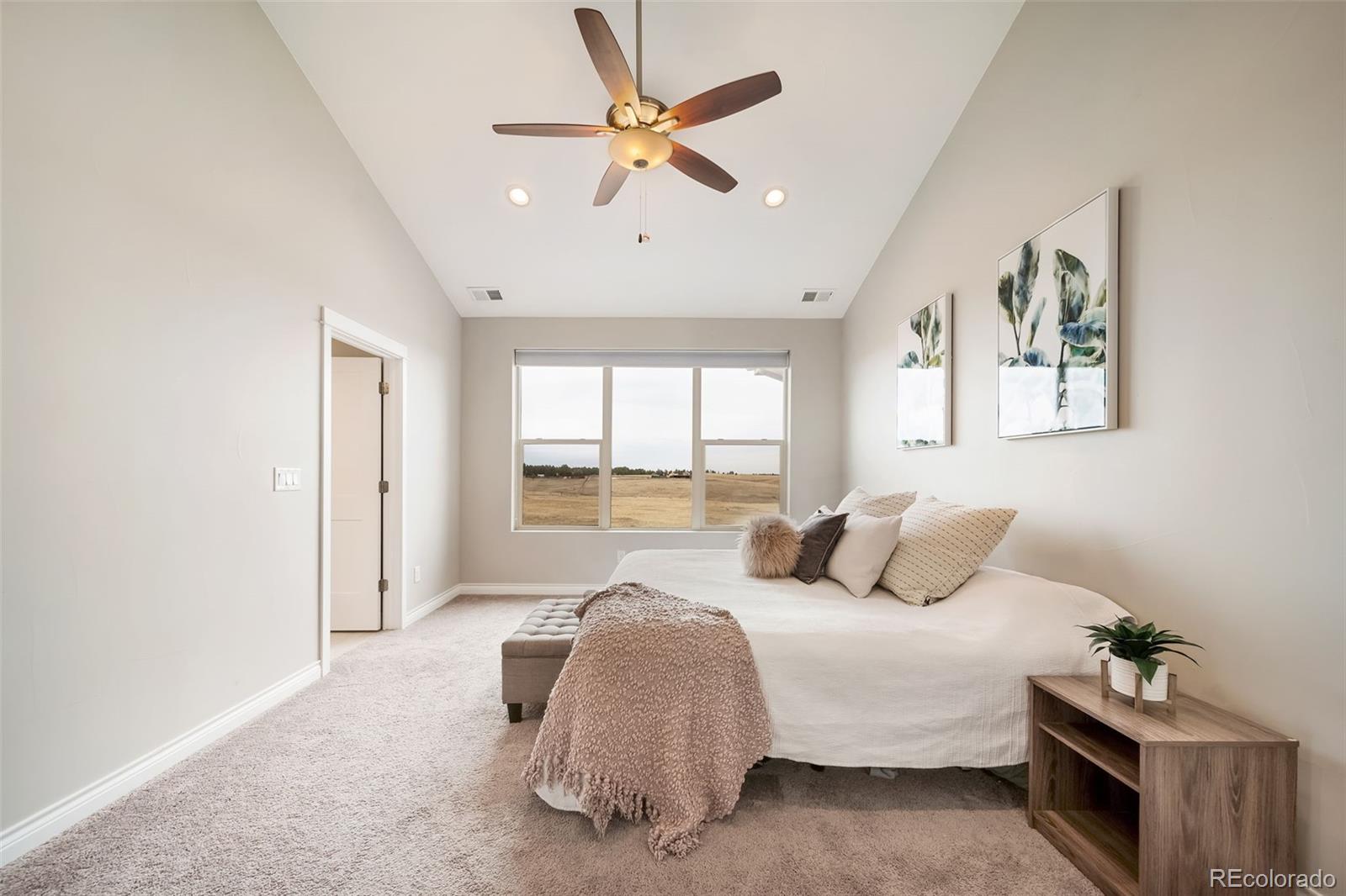 240 High Meadows Loop Elizabeth, CO 80107 - Photo 29 of 50 a bedroom with a bed and a large window