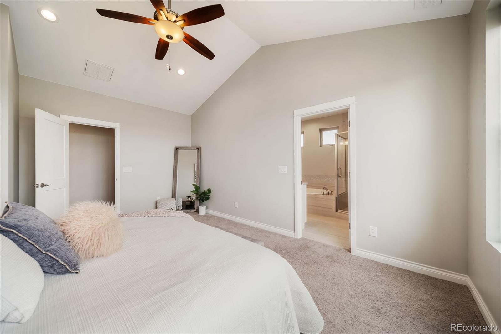 240 High Meadows Loop Elizabeth, CO 80107 - Photo 31 of 50 a bedroom with a bed and a chandelier