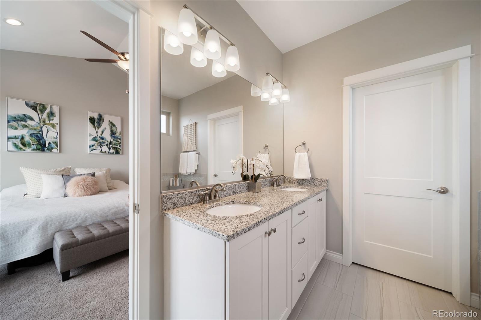 240 High Meadows Loop Elizabeth, CO 80107 - Photo 32 of 50 a en suite bathroom with a granite countertop double vanity sink and a mirror