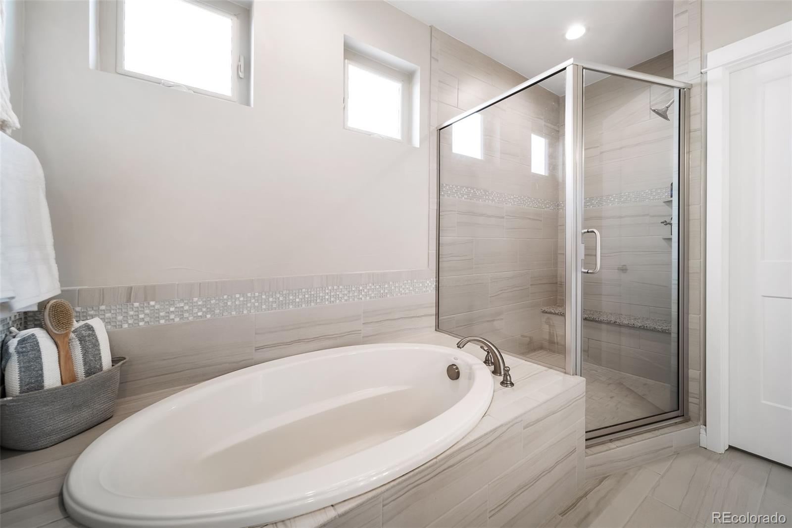 240 High Meadows Loop Elizabeth, CO 80107 - Photo 34 of 50 a bathroom with a bathtub and a shower