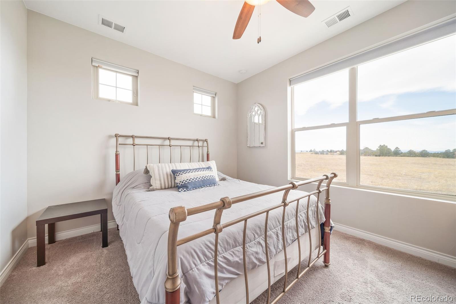 240 High Meadows Loop Elizabeth, CO 80107 - Photo 35 of 50 a bedroom with a bed and a large window