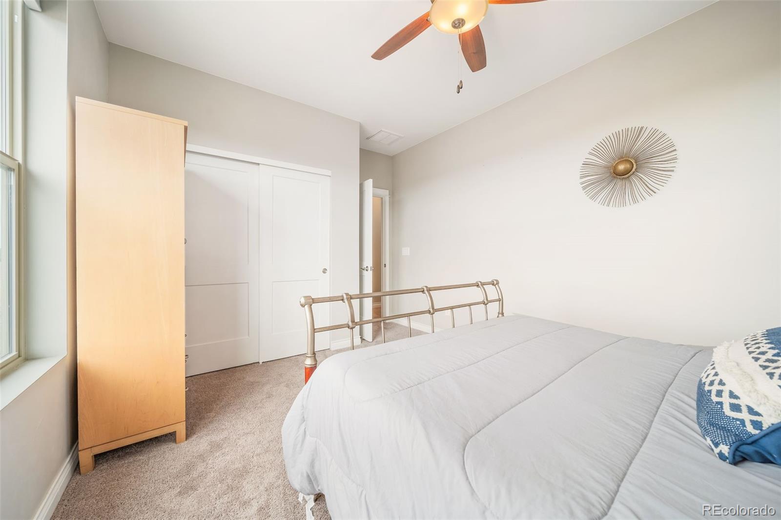 240 High Meadows Loop Elizabeth, CO 80107 - Photo 36 of 50 a bedroom with a bed and a chandelier