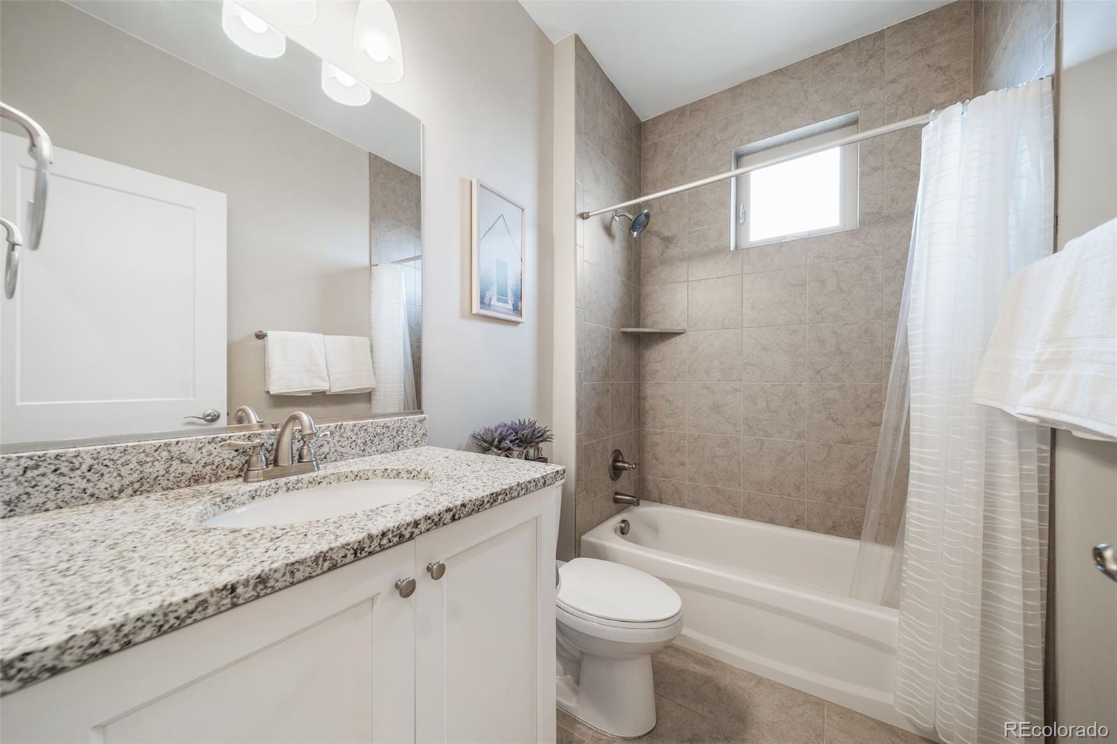 240 High Meadows Loop Elizabeth, CO 80107 - Photo 38 of 50 a bathroom with a granite countertop sink toilet and shower