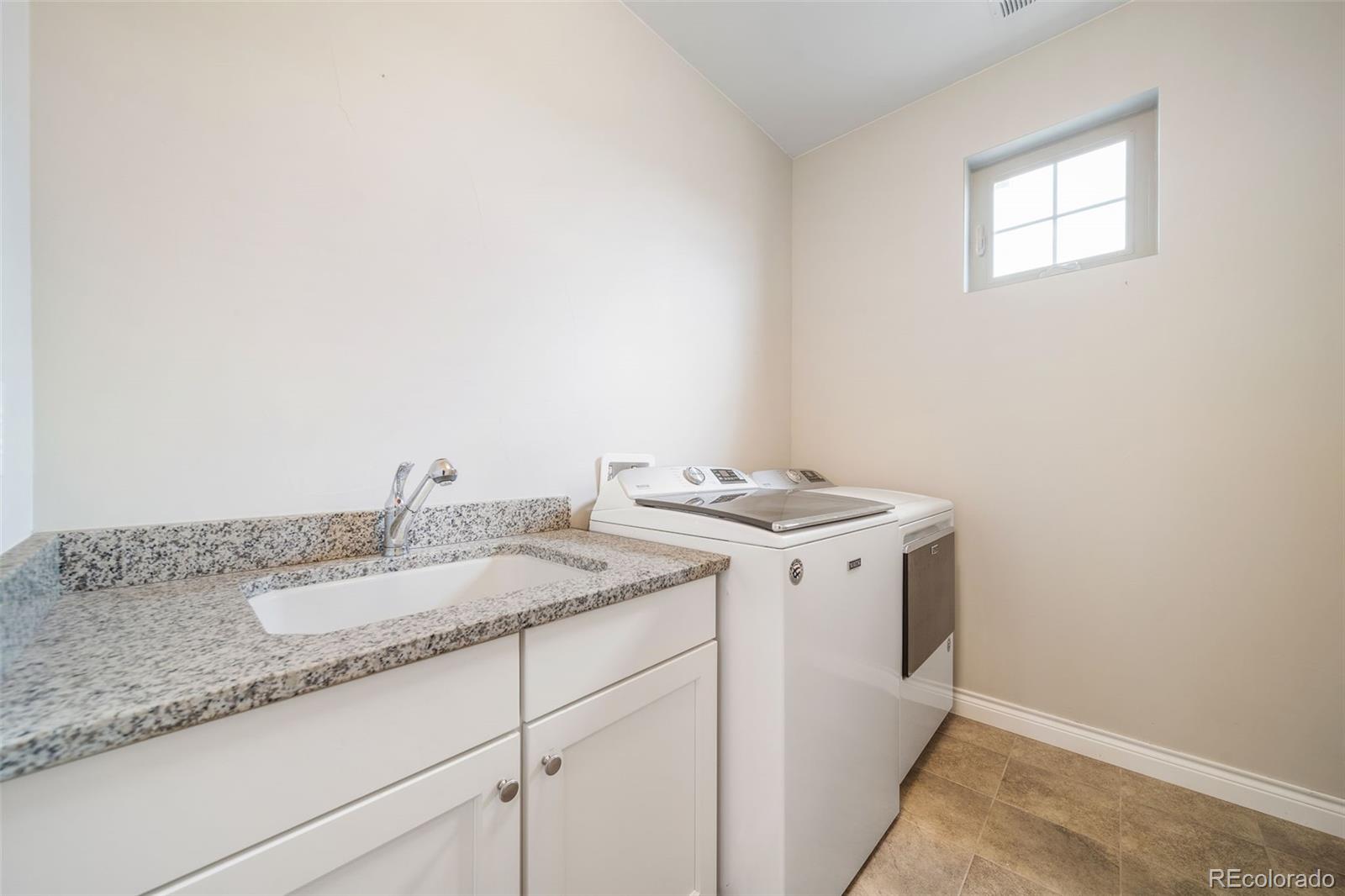 240 High Meadows Loop Elizabeth, CO 80107 - Photo 41 of 50 a utility room with sink dryer and washer