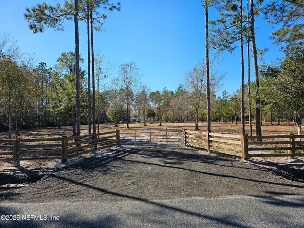 a view of a yard with street next to a road