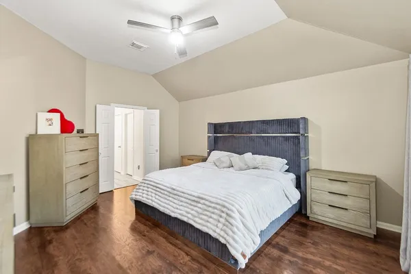 a bedroom with a bed and a dresser